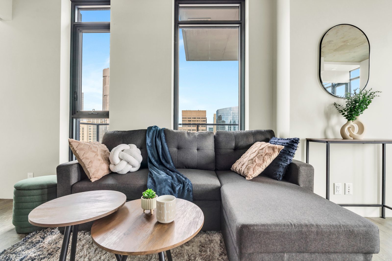 Staged Calgary condo living room prepared for Airbnb listing photos by District One